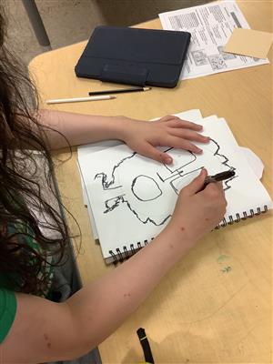 Student working on their sketch. 